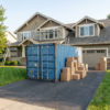 Blue 20ft shipping container on a suburban driveway during a renovation
