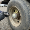 Inspecting the wheel hub and tire of a used cargo trailer