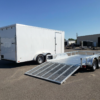 Enclosed cargo trailer next to an open utility trailer comparison