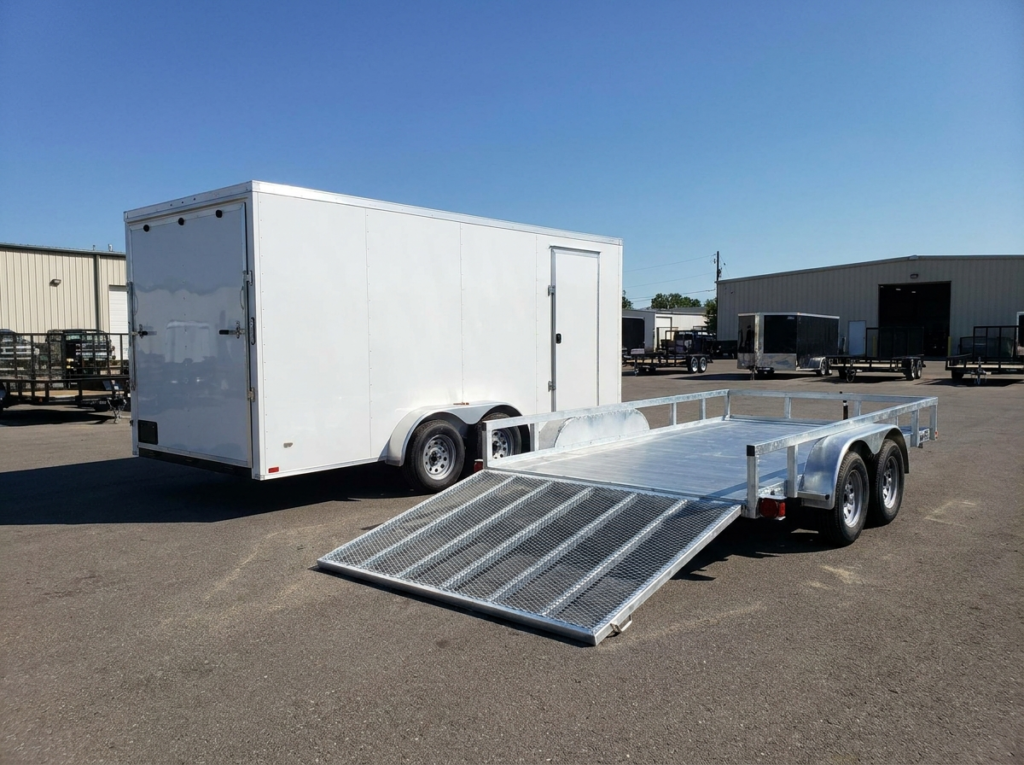 Enclosed cargo trailer next to an open utility trailer comparison