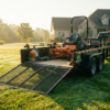 Utility trailer loaded with a zero-turn mower and lawn equipment